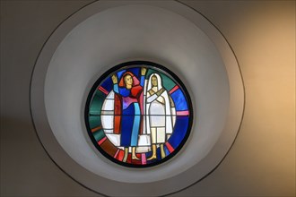 Modern church window with two figures