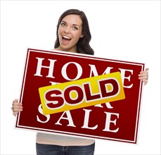 Happy mixed-race female with sold home for sale real estate sign isolated on white