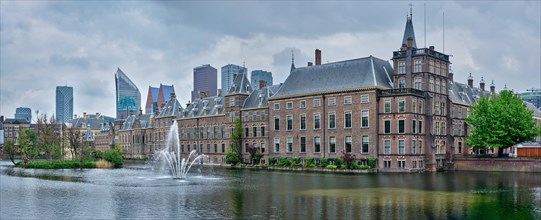 Panorama of the Binnenhof House of Parliament and the Hofvijver lake with downtown skyscrapers in background