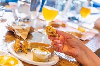 Woman enjoys warm pretzels and micro brew beer