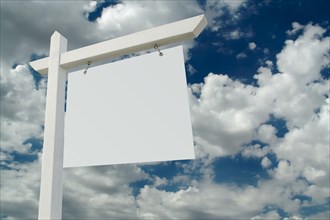 Blank real estate sign on clouds & sky background