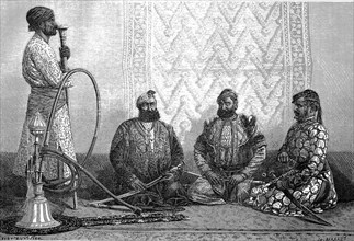 Men smoking hookah in a Hindustan teahouse in 1880