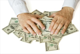 Greedy hands grabbing money lot of dollars