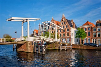 Gravestenenbrug bridge on Spaarne river and old houses in Haarlem