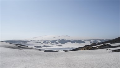 Barren volcanic landscape of snow and lava sand
