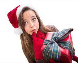 Thinking girl wearing A christmas santa hat with bow wrapped gift isolated on white