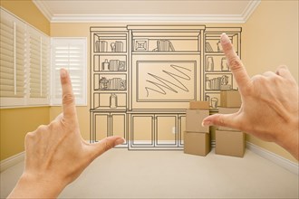 Framing hands of shelf design drawing on wall in empty room