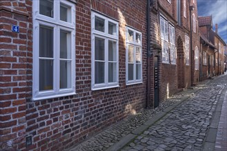 Historic brick houses in a cobbled lane