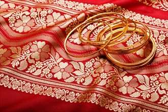 Indian sari with golden bangles clouse up