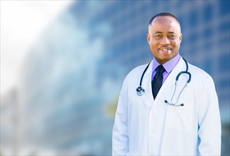Handsome african american male doctor outside of hospital building