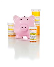 Piggy bank and non-proprietary medicine prescription bottles isolated on a white background