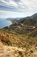 View from La Granatilla viewpoint of winding coastal road and viaduct in hilly landscape. Cabo de Gata Nijar nature Park