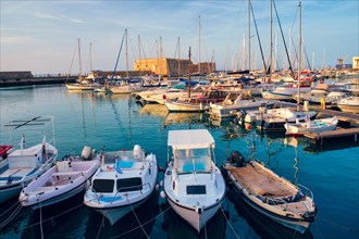 Venetian Fort castle in Heraklion and moored fishing boats