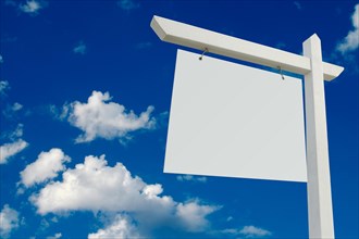 Blank real estate sign on clouds & sky background