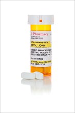 Non-Proprietary medicine prescription bottle and pills isolated on a white background