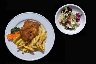 Schnitzel Viennese style with french fries with mixed salad plate