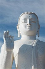 White sitting Budha image close up Mihintale