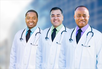 Handsome african american and hispanic male doctors outside of hospital building