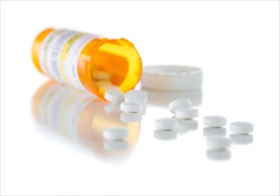 Non-Proprietary medicine prescription bottle and spilled pills isolated on a white background