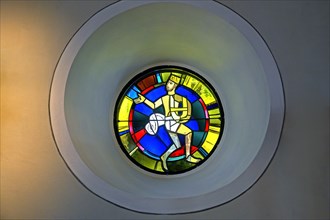 Modern church window with a figure