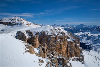 View of a ski resort piste and Dolomites mountains in Italy from Passo Pordoi pass. Arabba