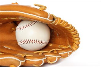 Baseball catcher mitt with ball on white background close up