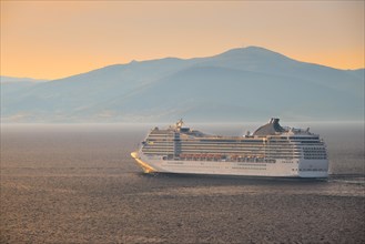 Cruise ship in Aegean sea on sunset. Mykonos island