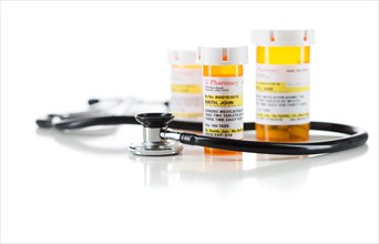 Group of non-proprietary medicine prescription bottle with stethoscope isolated on a white background