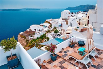 Famous greek iconic selfie spot tourist destination Oia village with traditional white houses and windmills in Santorini island