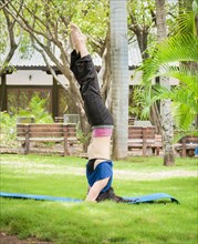 Girl doing headstand yoga