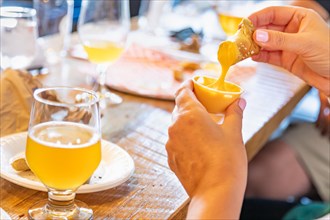 Woman enjoys warm pretzels and micro brew beer