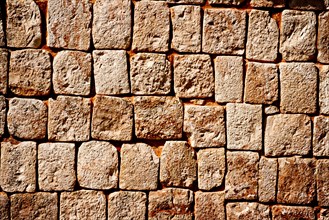 Texture of stone wall of ancient Mayan pyramids in Uxmal
