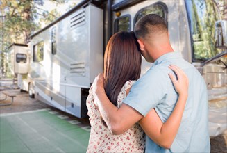 Young military couple looking at new RV