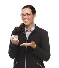 mixed-race businesswoman holding small house to the side isolated on a white background