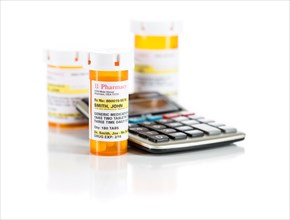 Calculator and non-proprietary medicine prescription bottles isolated on a white background