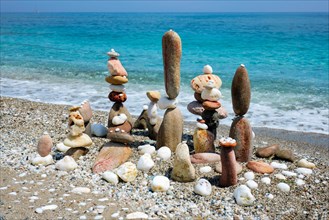 Concept of zen balance relaxation peace and harmony Pebbles stacks on the beach coast of the blue sea in the nature Meditative art of stone stacking