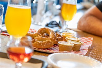 Abstract of small glass of micro brew beers and warm pretzels on bar