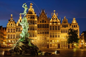 Antwerp famous Brabo statue and fountain on Grote Markt square illuminated at night and old houses Antwerp