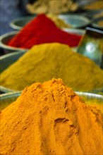 Turmeric curcuma powder and chili powder in spices market in India. Sardar Market