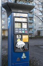 Modern parking meter with mobile phone parking number