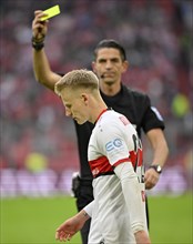 Referee Deniz Aytekin shows yellow card to Chris Fuehrich VfB Stuttgart