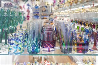 Colourful drinking glasses made in Murano on display in a shop in Venice