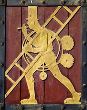 Historic figure on the door to the Ratskeller representing the craft of the chimney sweep