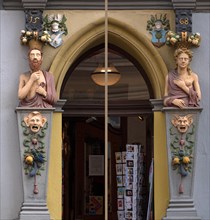 Male and female Renaissance figures on an entrance portal from 1568