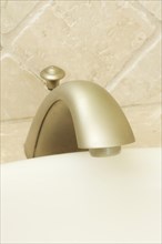 Close-up of sink faucet and tile