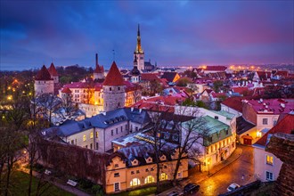 Aerial view of Tallinn Medieval Old Town illuminated in evening with dramatic sky