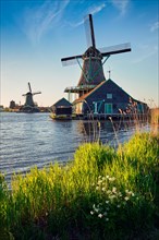Windmills at famous tourist site Zaanse Schans in Holland on sunset. Zaandam
