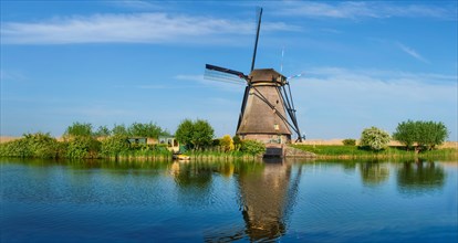 Panorama of Netherlands rural landscape with windmills at famous tourist site Kinderdijk in Holland