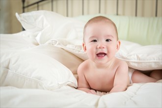 Young mixed-race chinese and caucasian baby boy having fun on his blanket