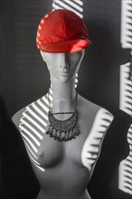 White fashion doll with red baseball cap and oriental silver jewellery